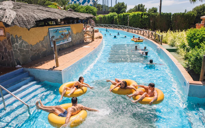 Visitors enjoying the lazy river at Aqualandia Benidorm, Spain.