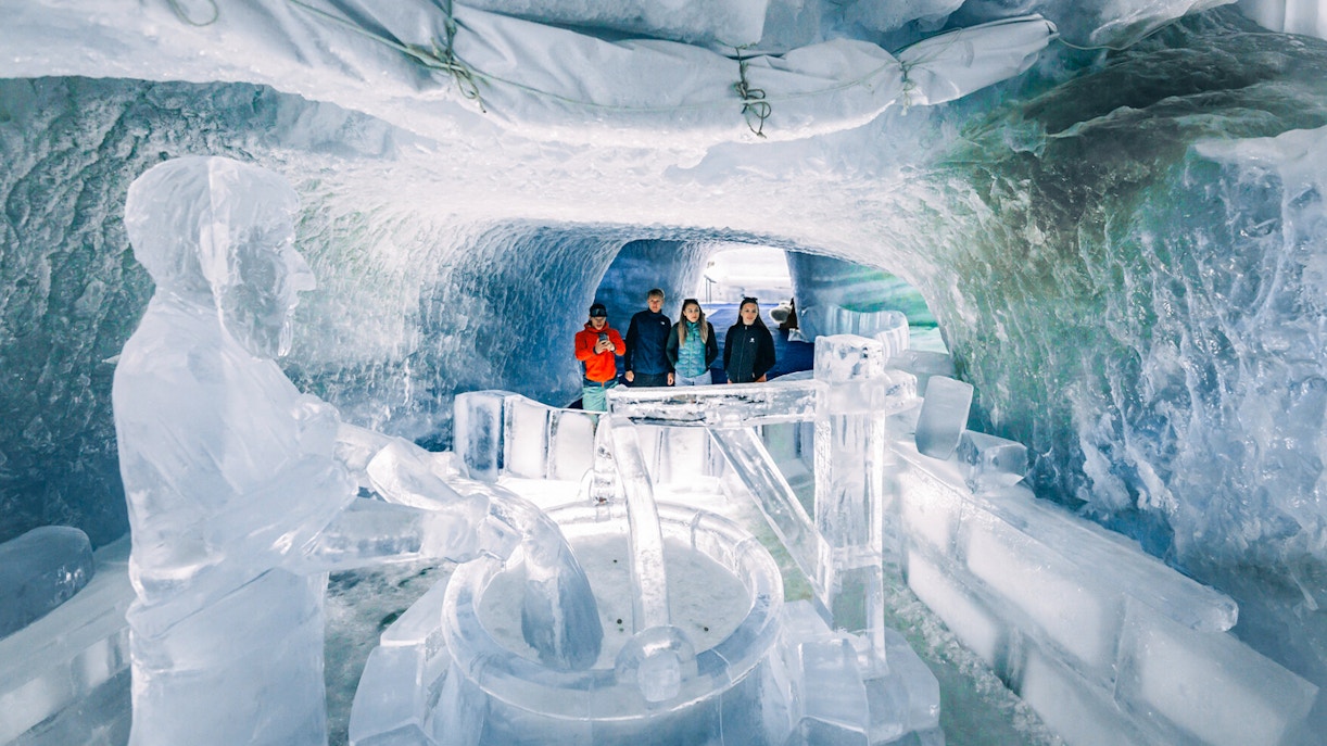 Visitors exploring ice sculptures inside Glacier Paradise.