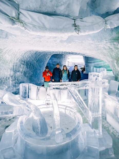 Visitors exploring ice sculptures inside Glacier Paradise.