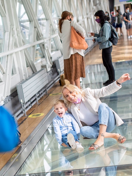 Visitors enjoying the glass walkway at Tower Bridge, London.
