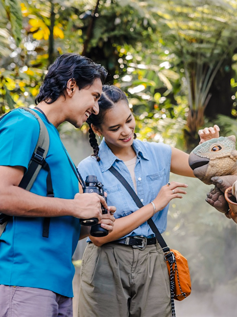 Visitors interacting with a dinosaur puppet at Jurassic World experience, Gardens by the Bay.