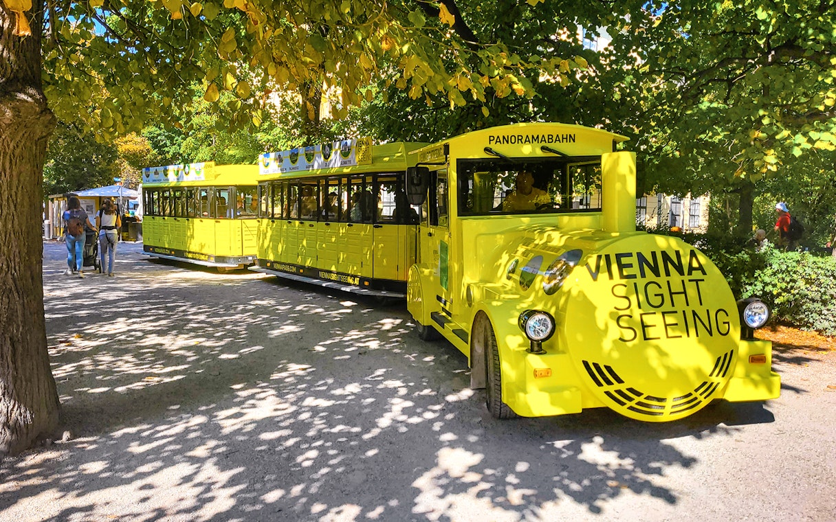Schönbrunn Palace Panorama Train in Vienna park setting.