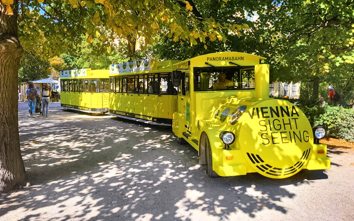 Schönbrunn Palace Panorama Train in Vienna park setting.