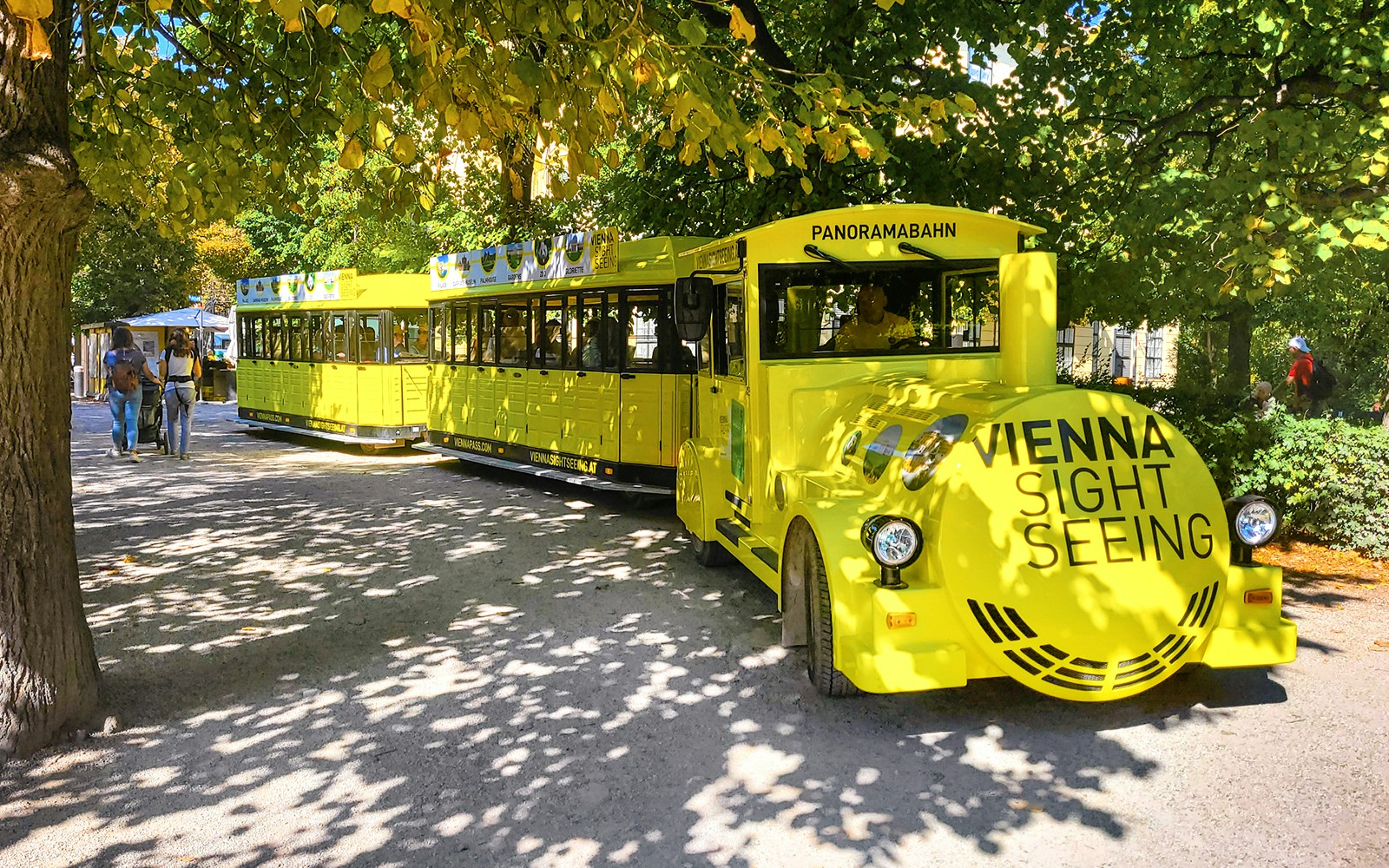 Schönbrunn Palace Panorama Train in Vienna park setting.
