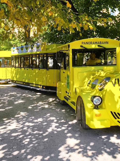 Schönbrunn Palace Panorama Train in Vienna park setting.