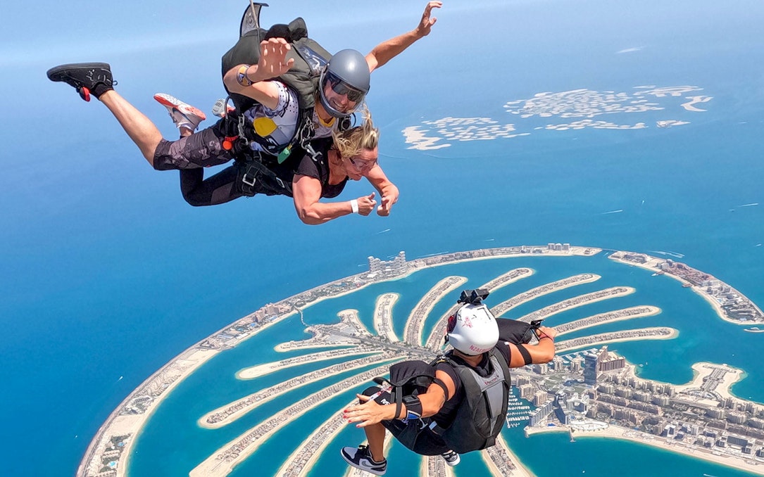 Skydivers over Palm Jumeirah, Dubai, with Skydive Dubai experience.