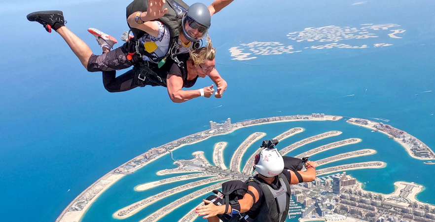Skydivers over Palm Jumeirah, Dubai, with Skydive Dubai experience.
