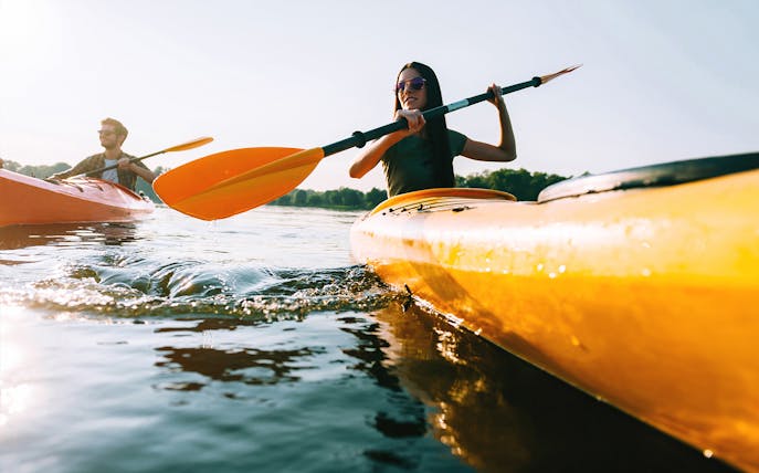 Kayakers paddling on a lake during the Guided Biking & Kayaking Tour at Furnas.