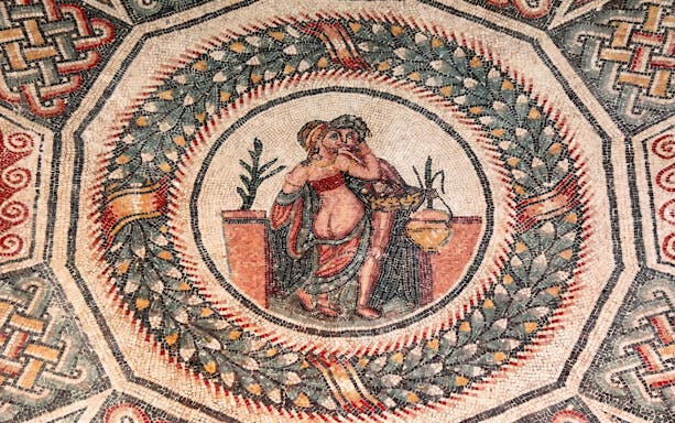 Ancient Roman mosaic depicting figures in Villa Romana del Casale, Piazza Armerina.