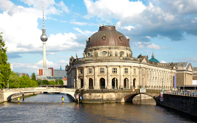 Bode Museum on the Spree River with Berlin TV Tower in the background.