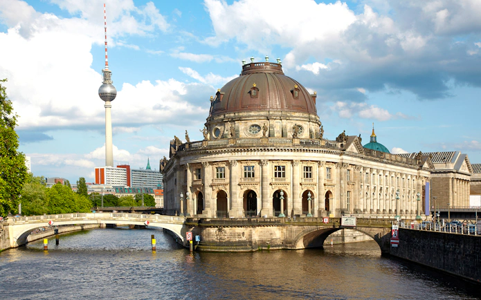 Bode Museum on the Spree River with Berlin TV Tower in the background.