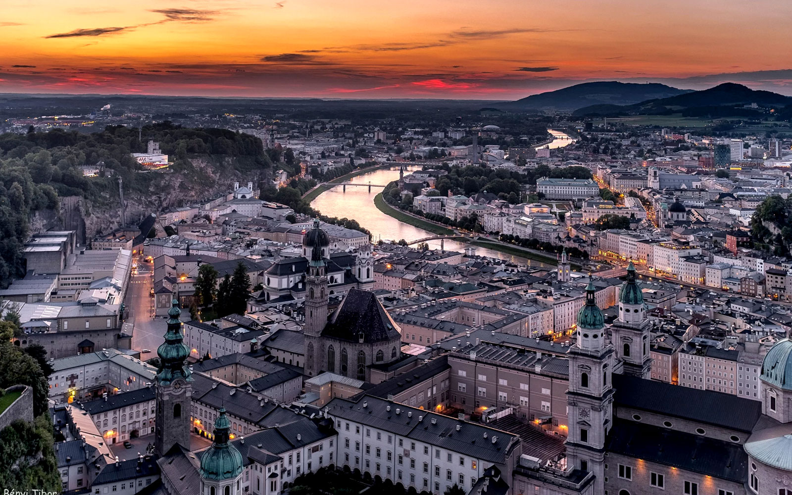 Aerial view of Salzburg at sunset with Fortress Hohensalzburg and Salzach River.