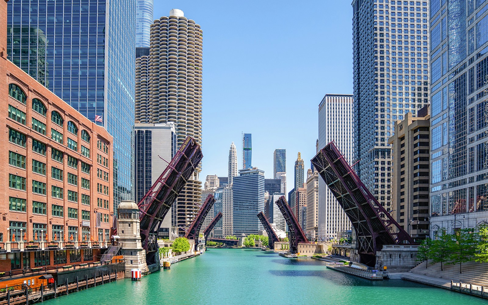 Chicago River with raised lift bridges and skyline during architecture cruise.