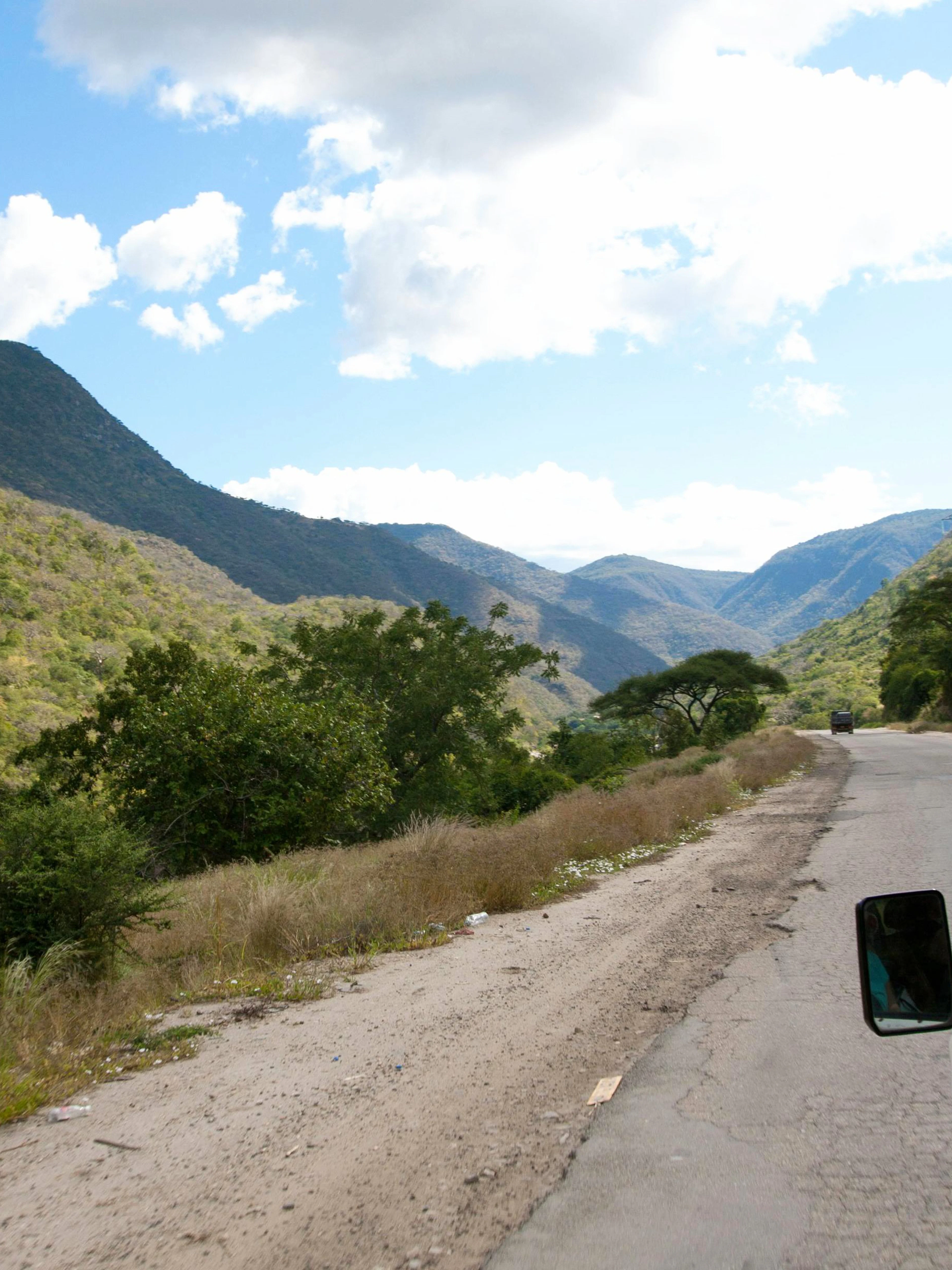 Driving through scenic mountain road towards Mount Kenya.
