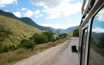 Driving through scenic mountain road towards Mount Kenya.
