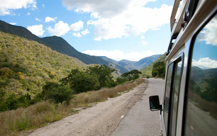 Driving through scenic mountain road towards Mount Kenya.