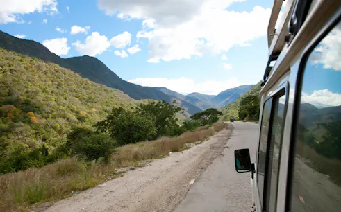 Driving through scenic mountain road towards Mount Kenya.