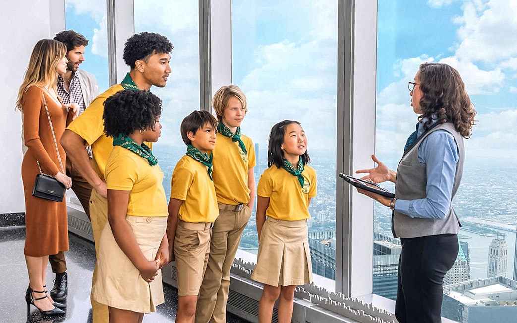 Group on One World Observatory VIP Tour overlooking New York City skyline.