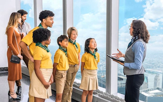 Group on One World Observatory VIP Tour overlooking New York City skyline.