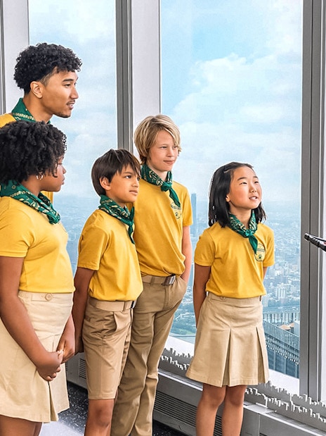 Group on One World Observatory VIP Tour overlooking New York City skyline.