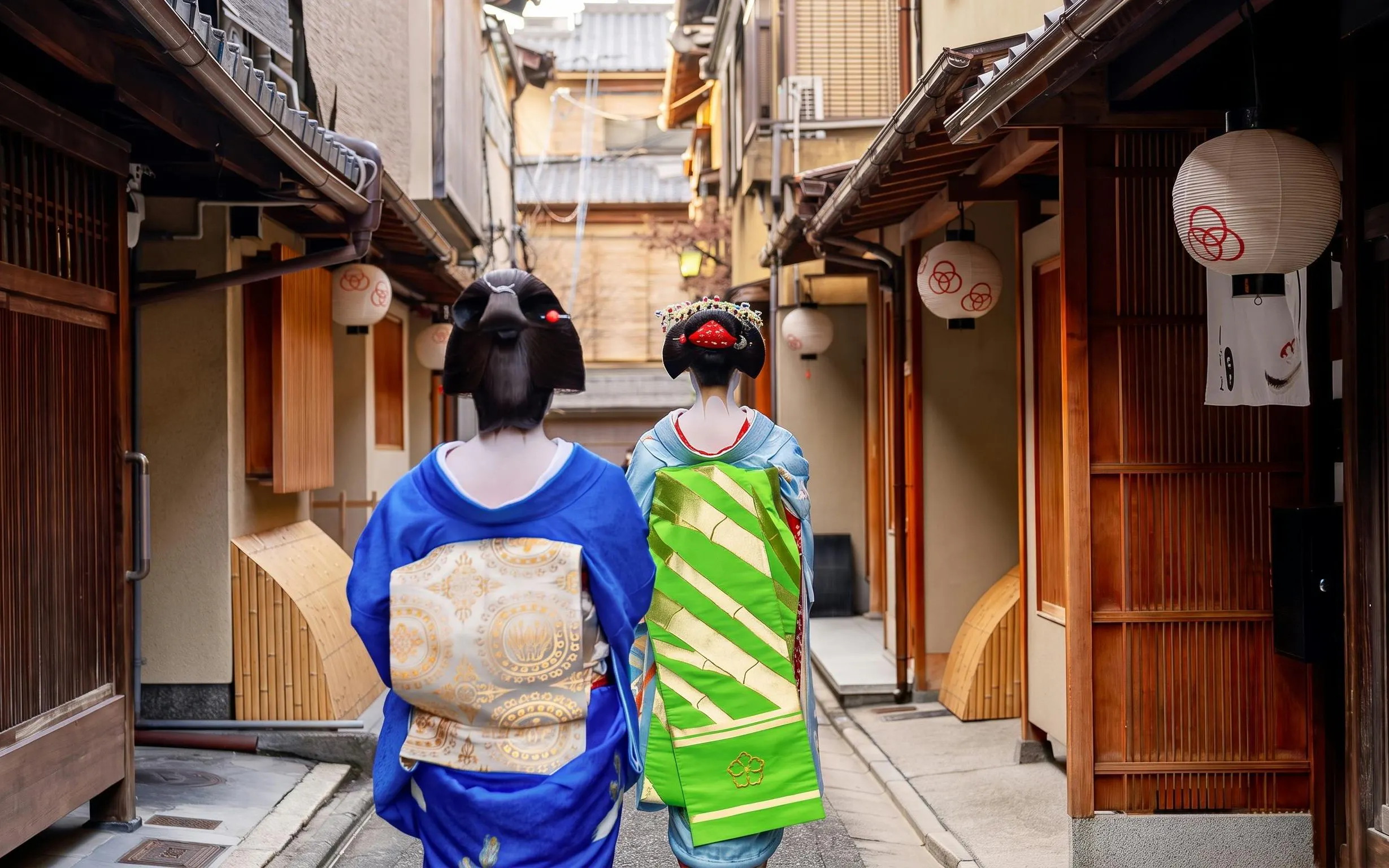 Geishas walking through a historic neighborhood in Kyoto, Japan.