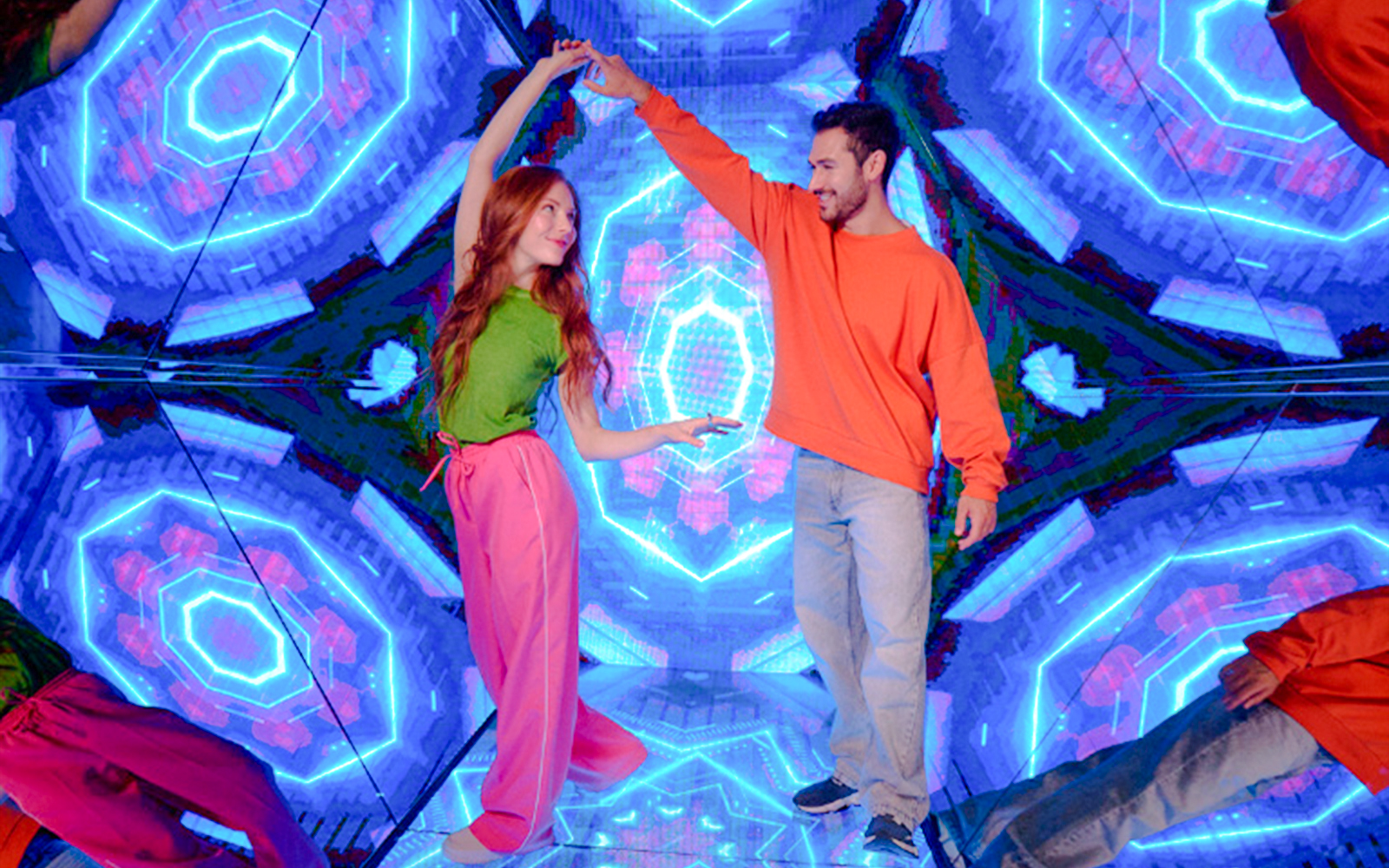 Guests enjoying interactive exhibit at Paradox Museum London with vibrant neon lights.