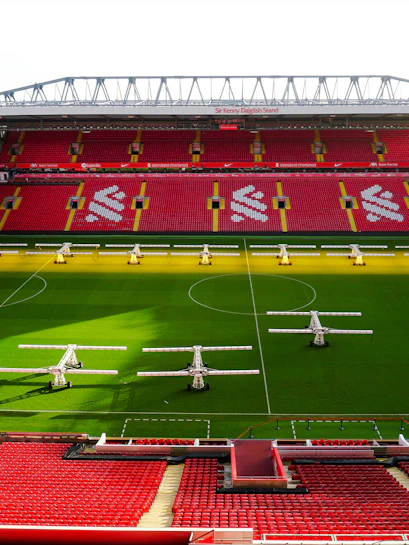 Liverpool FC stadium aerial view, showcasing the iconic red exterior and surrounding cityscape.