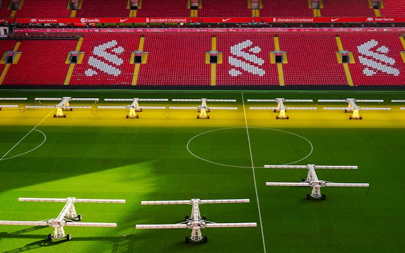 Liverpool FC stadium aerial view, showcasing the iconic red exterior and surrounding cityscape.