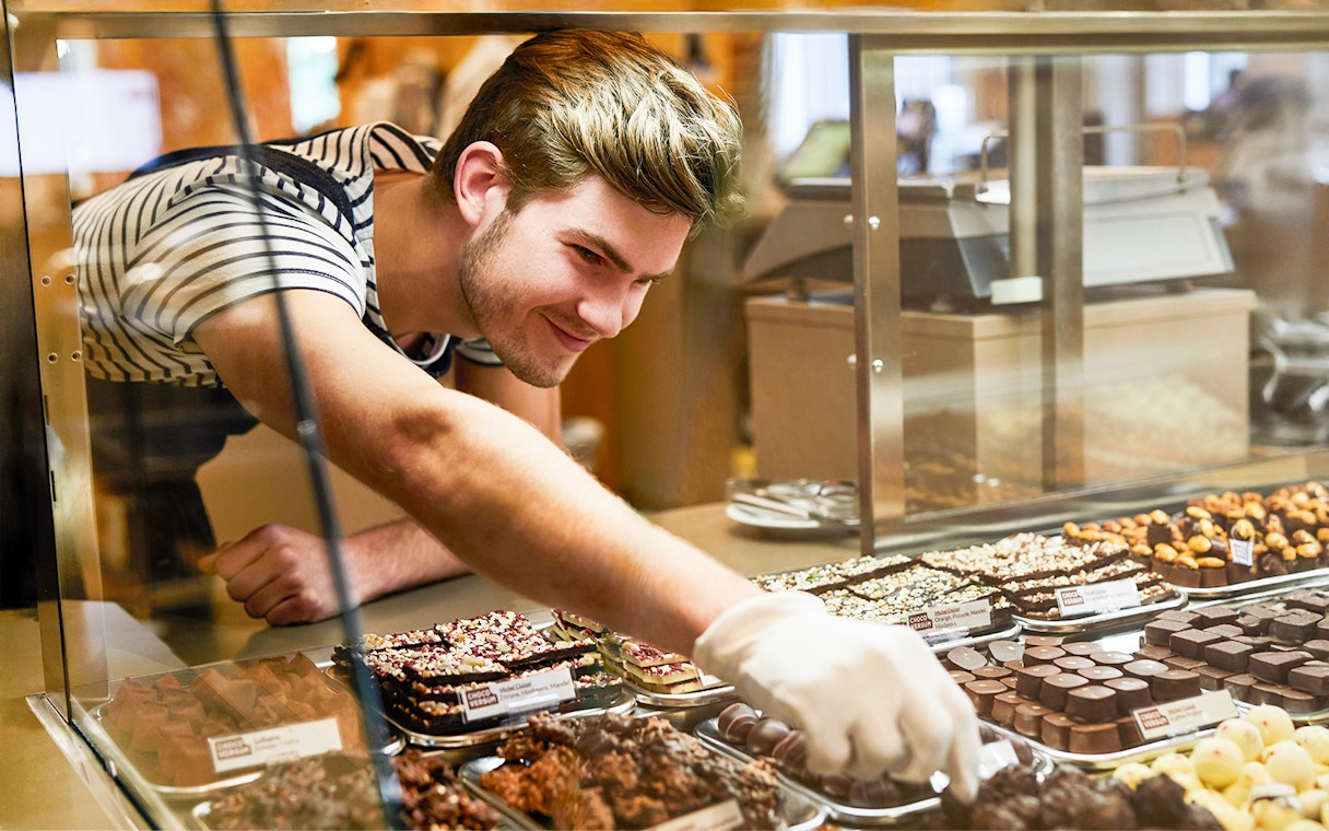 Staff selecting chocolates for guests at Chocoversum, Hamburg.