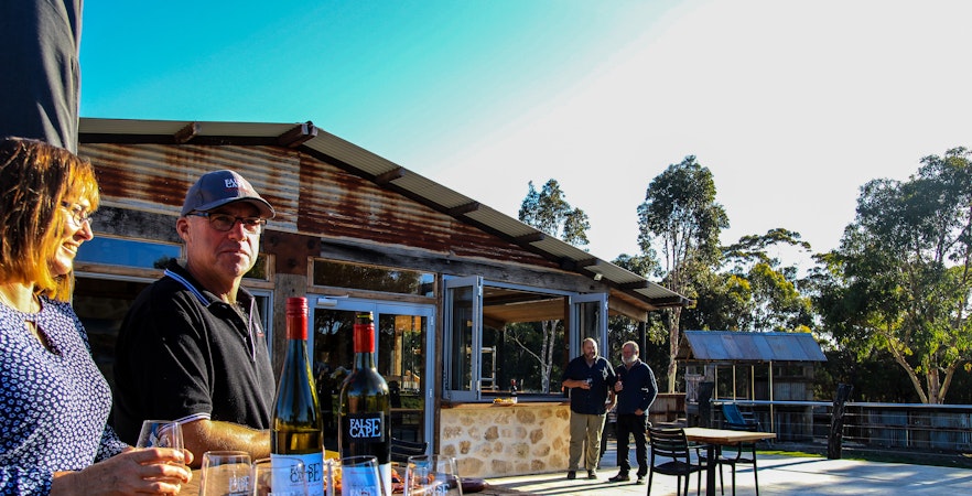 People enjoying wine at a rustic winery in False Cape, Kangaroo Island.