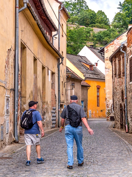 Tourists walking through a narrow cobblestone street in Cesky Krumlov.
