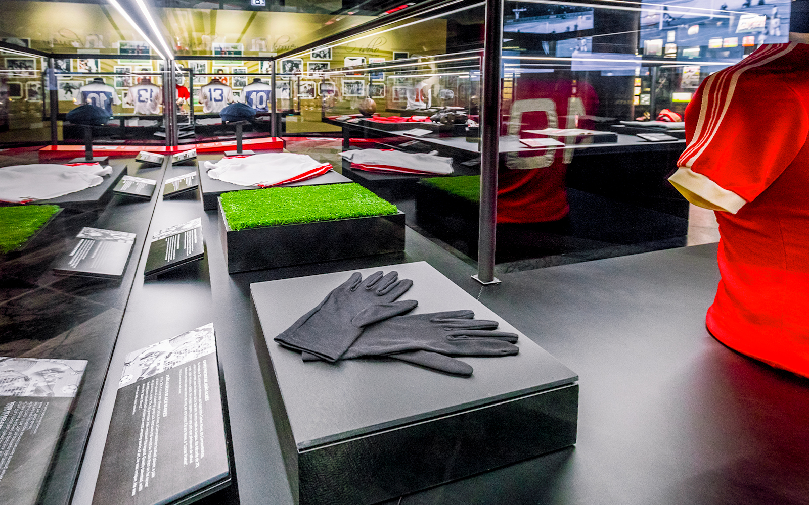 Benfica Stadium museum display with football memorabilia and jerseys.