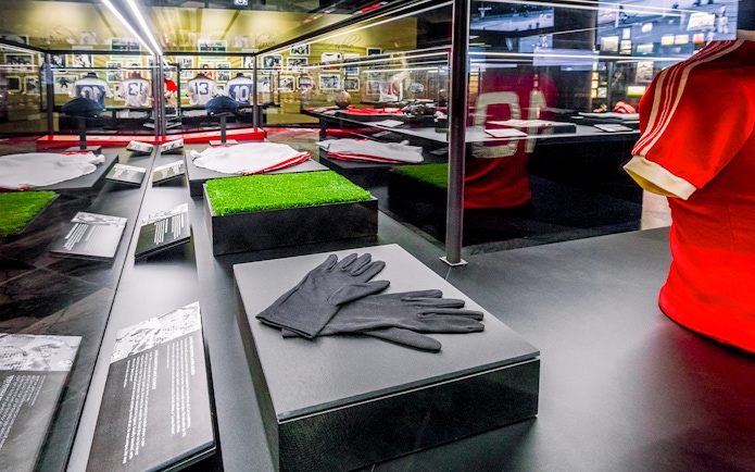 Benfica Stadium museum display with football memorabilia and jerseys.