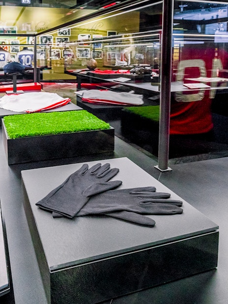 Benfica Stadium museum display with football memorabilia and jerseys.
