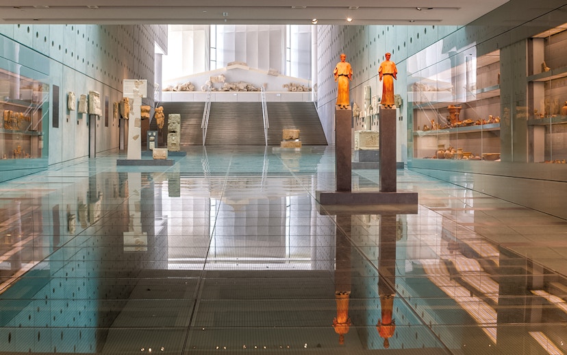 Acropolis Museum interior with ancient statues and artifacts on display.