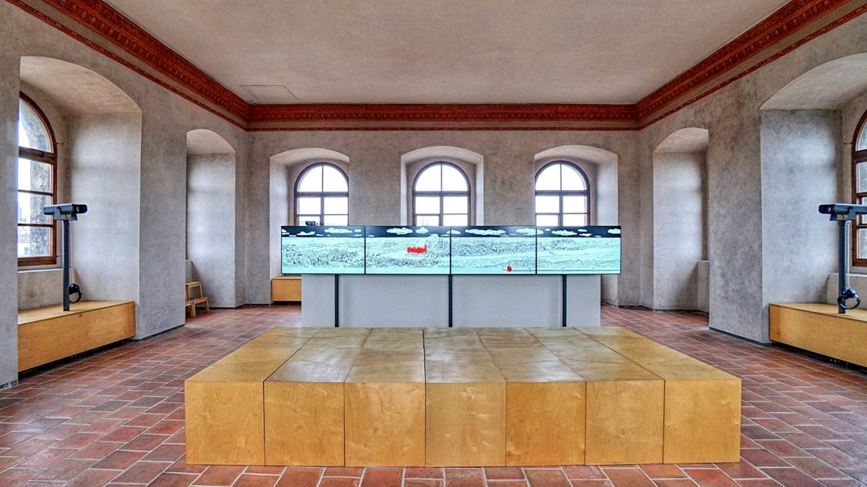 Interior of The New Mill Water Tower in Prague with digital display and arched windows.