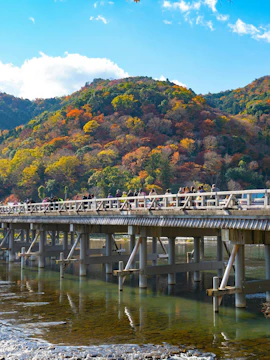 Togetsukyo Bridge with autumn foliage in Arashiyama, Kyoto.