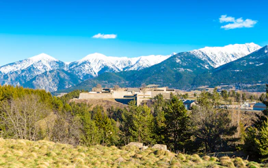 Fortification de Mont-Louis with snow-capped mountains in the background.