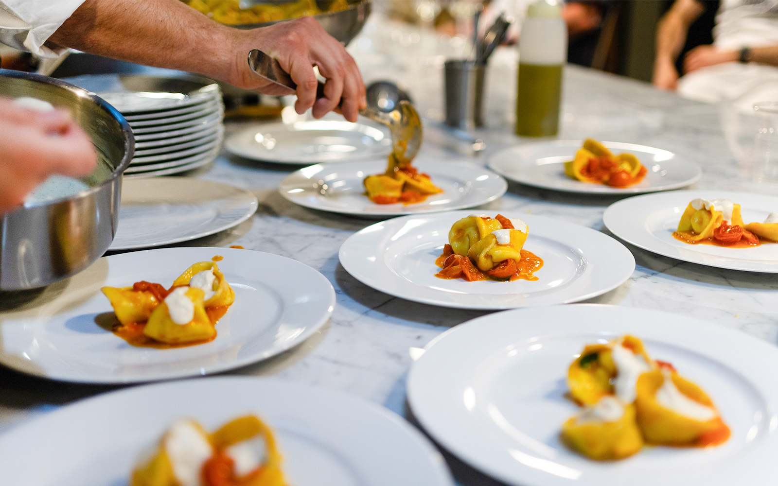 Plating tortellini during a Florence pasta-making class.