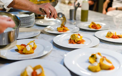 Plating tortellini during a Florence pasta-making class.