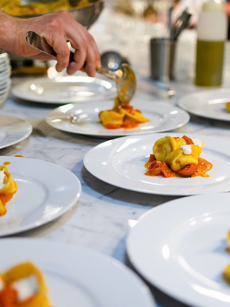Plating tortellini during a Florence pasta-making class.