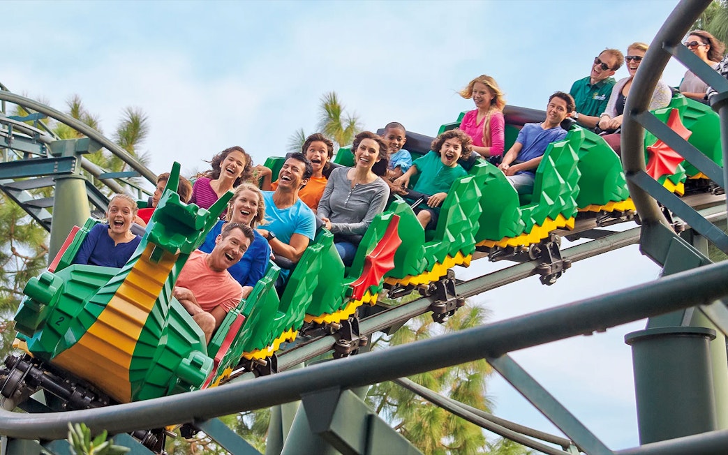 Visitors enjoying a dragon-themed roller coaster at LEGOLAND Korea.