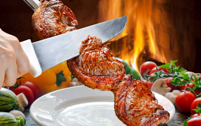 Slicing grilled meat at a Brazilian steakhouse in Rio de Janeiro.