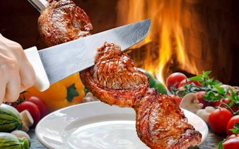 Slicing grilled meat at a Brazilian steakhouse in Rio de Janeiro.