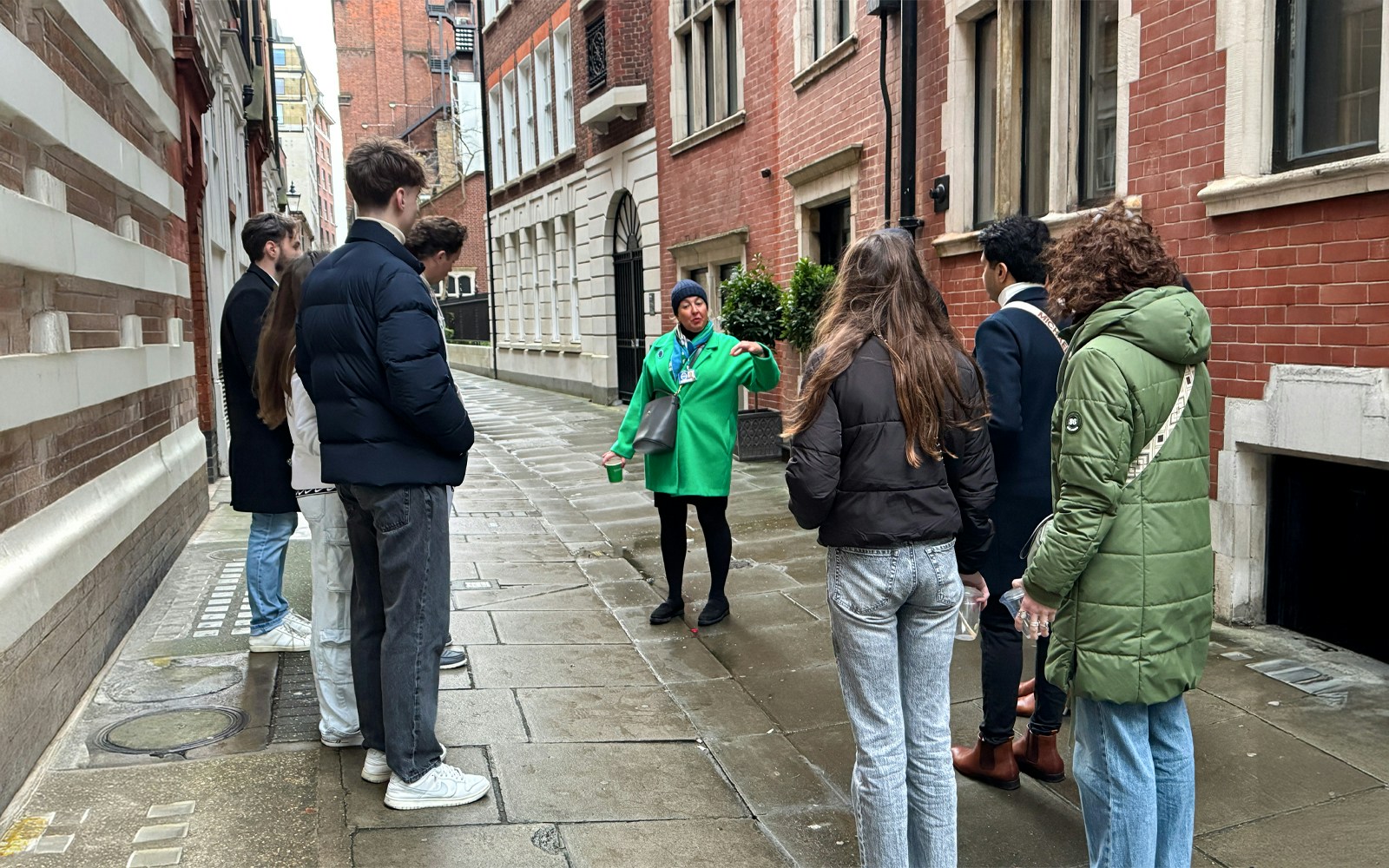 Tour guide leading a group through a historic London street near Westminster Abbey.