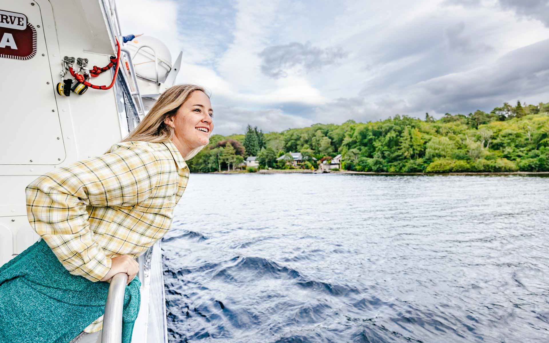Person enjoying a boat cruise on Loch Ness, Scottish Highlands.
