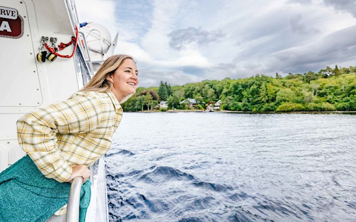 Person enjoying a boat cruise on Loch Ness, Scottish Highlands.