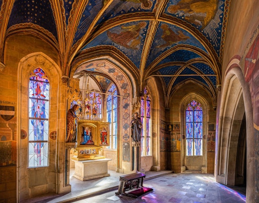 Interior of the Gothic Chapel of the Virgin Mary with stained glass windows in Prague's Old Town Hall.