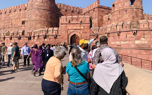 Tourists exploring Agra Fort with a guide during a private heritage tour in Agra.