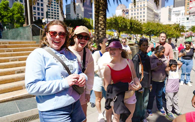 Tourists enjoying a sunny day at Union Square, San Francisco during a hop-on hop-off tour.